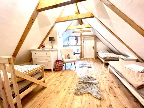 a attic room with a bed and a desk at Santova roubenka in Štramberk