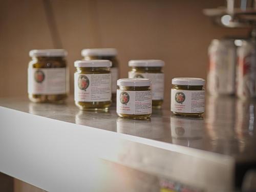 a row of jars of honey sitting on a counter at Quadrifoglio Relax in San Donà di Piave