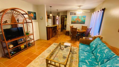 a living room with a couch and a table at Tradewinds Paradise Villas in San Pedro