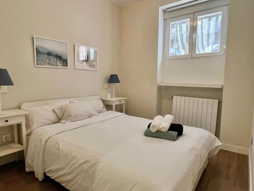a bedroom with a bed with two towels on it at Apartamentos Chamberí in Madrid