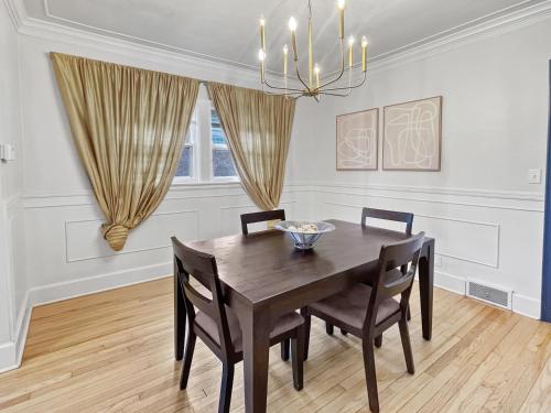 a dining room with a wooden table and chairs at Cozy 3br Home By Ingersoll Restaurant Scene in Des Moines