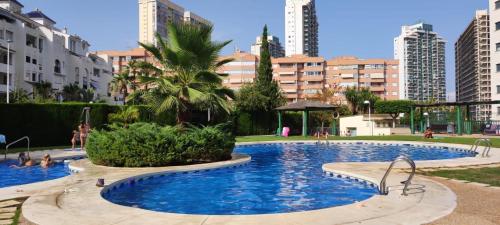 a large swimming pool in a city with tall buildings at Apartamento Vistas al mar en Gemelos 24 La Cala de Finestrat in Alicante