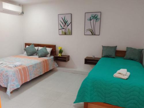 a bedroom with two beds in a room at Habitaciones Ciudad Amurallada in Cartagena de Indias