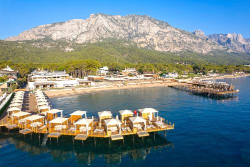 an aerial view of a beach with chairs and a dock at Siu Collection - Ultra All Inclusive in Beldibi