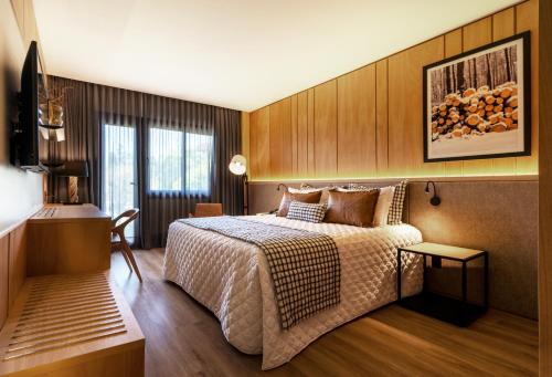 Ένα ή περισσότερα κρεβάτια σε δωμάτιο στο Hotel Alpestre