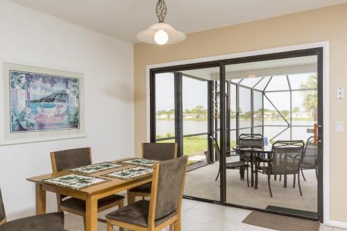 a dining room with a table and chairs at Addy by the Lake in Port Charlotte