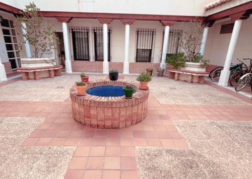 a courtyard with a fountain in front of a building at El rincón exquisito in Albacete