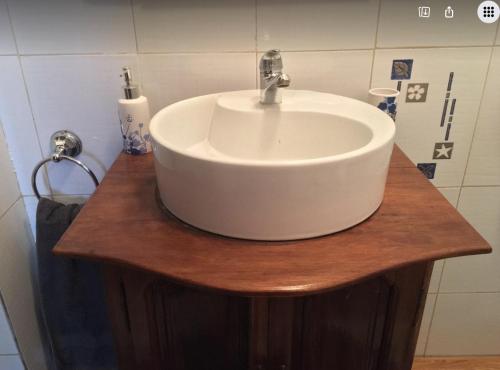 a white sink on a wooden counter in a bathroom at Iarimbato Hotel in Antananarivo