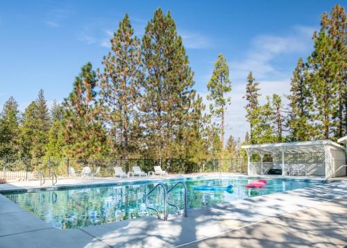 a swimming pool with trees in the background at Inn at Sugar Pine Ranch in Groveland