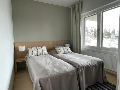 a bedroom with a bed and a window at R-Chalet Ruka (2302) in Ruka