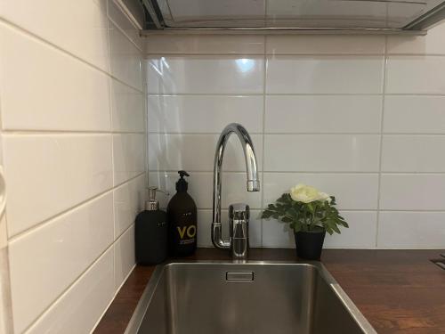a kitchen sink with a faucet in a kitchen at Stylish Studio at the Heart of Helsinki in Helsinki