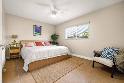 a bedroom with a bed and a chair and a window at Beach Apartment Walk Downtown in Santa Barbara