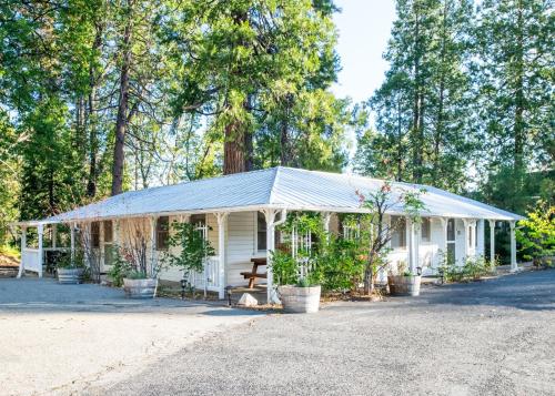 a small white house with a tin roof at Inn at Sugar Pine Ranch in Groveland