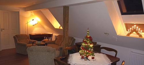 a living room with a christmas tree on a table at Gemütliche Wohnung am Wald in Loosen