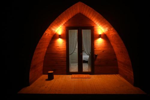 a small room with a door and a window at Căsuțe în mijlocul naturii - Wild Camp Avrig in Avrig
