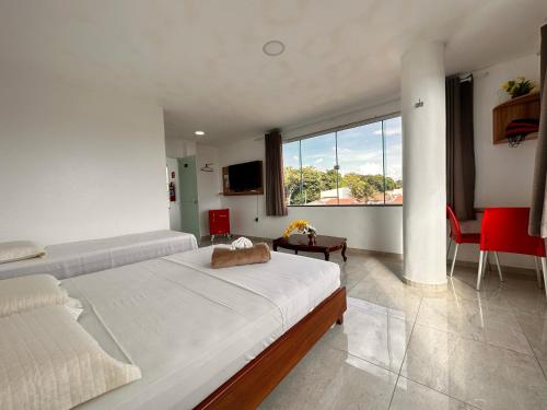 a bedroom with a large bed and a large window at Pousada Diamante in Ubajara