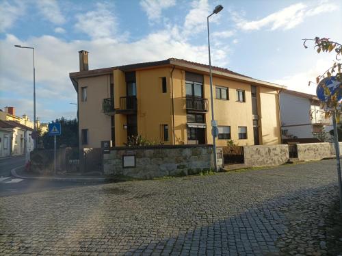 a yellow house on the side of a street at Yellow House in Senhora da Hora