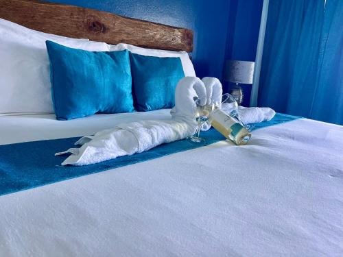 a bed with a towel shaped like a swan on it at Sand and Tan Beach Hotel in Ocho Rios