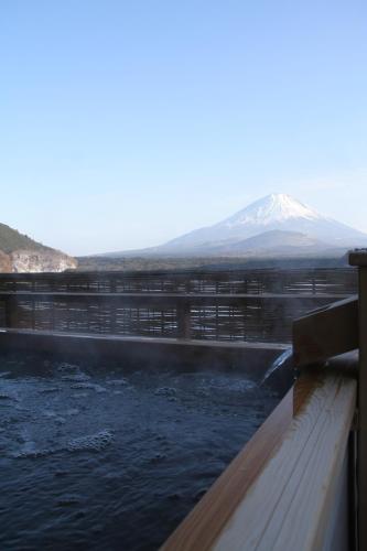 a water dam with a mountain in the background at Yamadaya Hotel in Fujikawaguchiko