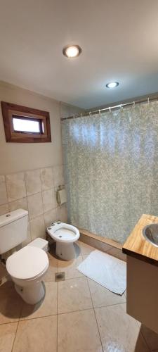 a bathroom with two toilets and a shower at El Retamo in San Carlos de Bariloche