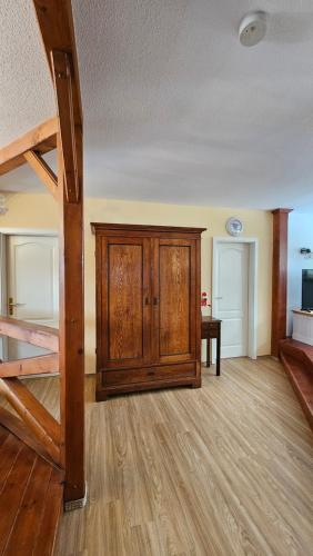 a room with a bunk bed and a wooden cabinet at Ferienwohnungen im Haus Lohme / Hagen in Hagen