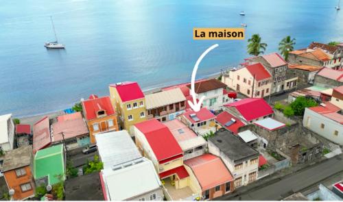 a group of buildings next to the water at Maison Bernabet - Rooftop avec vue sur la Montagne Pelée in Saint-Pierre