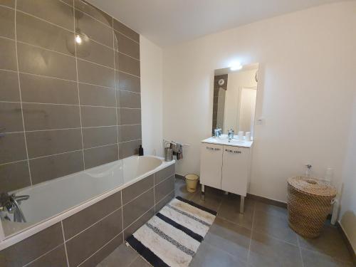 une salle de bain avec une baignoire et un lavabo dans l'établissement Lille Grand Palais, Europe, Bienvenue chez Nestyou, Lille, à Lille