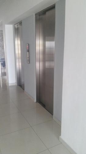 an empty hallway with a elevator in a building at LINCOLN SUITE in Santo Domingo