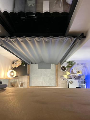 a room with a bed with a curtain on it at Modern 1-bed Duplex+Balcony in Manchester