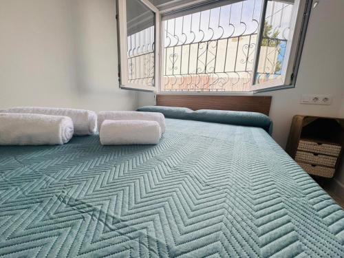 a large bed in a room with a window at Villa Don Paco in Las Negras