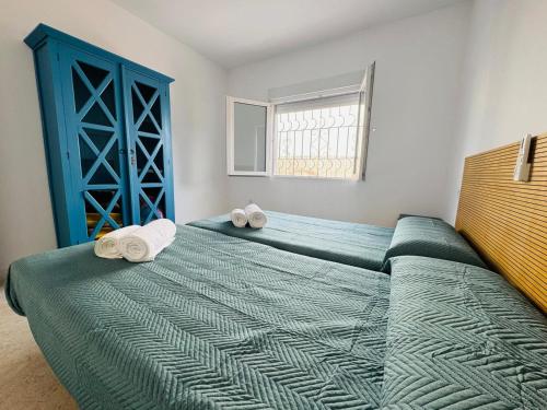 a bedroom with a bed with towels on it at Villa Don Paco in Las Negras