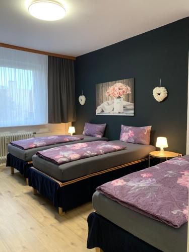 2 Betten in einem Zimmer mit blauen Wänden in der Unterkunft Just Berlin - Wohnung für bis zu 12 Personen in Berlin