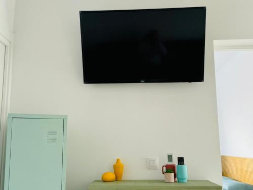 a flat screen tv hanging on a white wall at Villa Don Paco in Las Negras