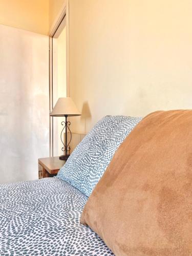 a bedroom with a bed and a lamp on a table at Berenice Housing in Prato