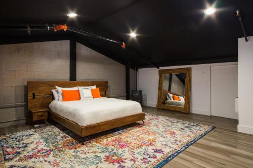 1 dormitorio con cama, alfombra y espejo en Petaluma Warehouse Lofts unit E en Petaluma