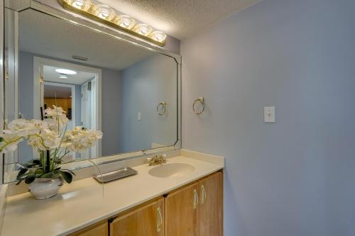a bathroom with a sink and a large mirror at Florida Apartment with Balcony, Pool Access and Views in Panama City Beach