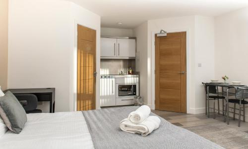 a bedroom with a bed with a towel on it at Cozy Studio Flat for Rent in Preston