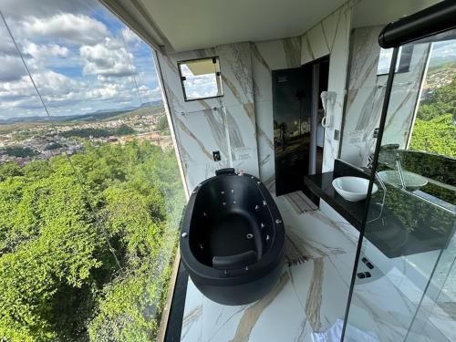 a bathroom with a toilet in the middle of a room at Pousada Circuito dos Inconfidentes in Congonhas