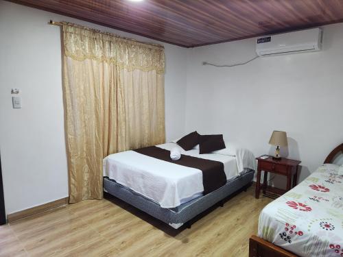 Postel nebo postele na pokoji v ubytování Hotel La Jungla