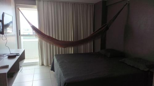 a bedroom with a bed and a window with a net at Apartamento West Flat Ap401 in Mossoró