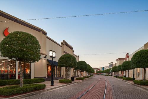 an empty street in a town with trees and buildings at TownePlace Suites by Marriott Bossier City in Bossier City
