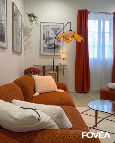 a living room with a couch and a lamp at Athéna in Caen