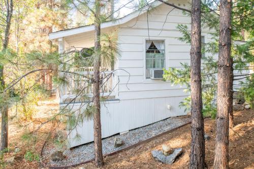 a white house with trees in front of it at Inn at Sugar Pine Ranch in Groveland