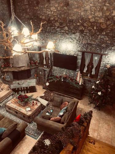a living room with a couch and a fireplace at Country Stone House ,next to Kalavrita in Kalavrita