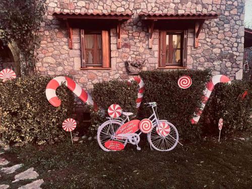 a bike parked in front of a house with candy canes at Country Stone House ,next to Kalavrita in Kalavrita