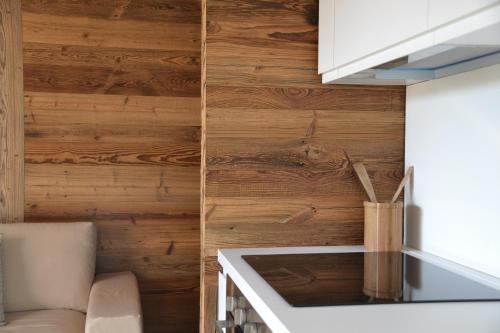 a kitchen with wooden walls and a counter top at Chalet Mont Blanc de Courmayeur in Courmayeur