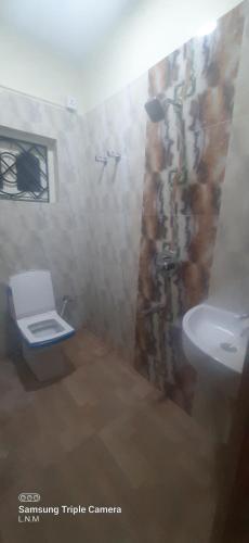 a bathroom with a toilet and a sink at Laxmi Niwas, Twin Sharing Room Salt lake, 10mins from Sector 5 in kolkata