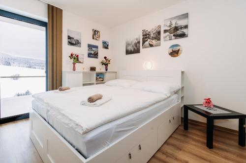 Un pat sau paturi într-o cameră la Horský apartmán Temari 14 Klínovec