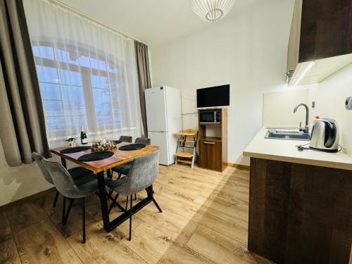 a kitchen with a table and chairs in a room at Apartmány KAMZÍK Donovaly in Donovaly