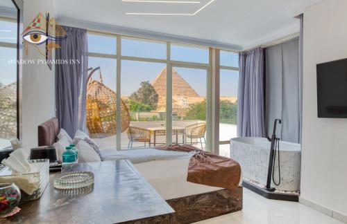 a living room with a view of the pyramids at Shadow Pyramids Palace in Cairo